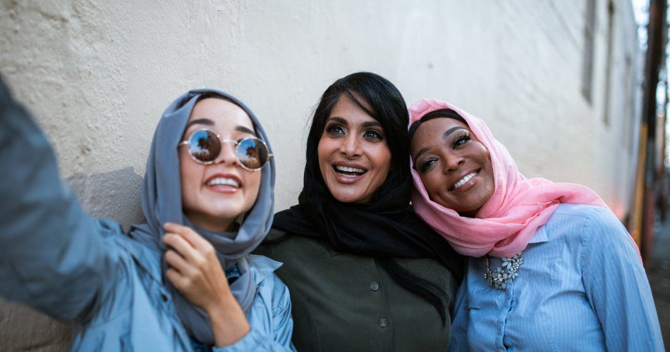 women wearing headscarves taking a selfie
