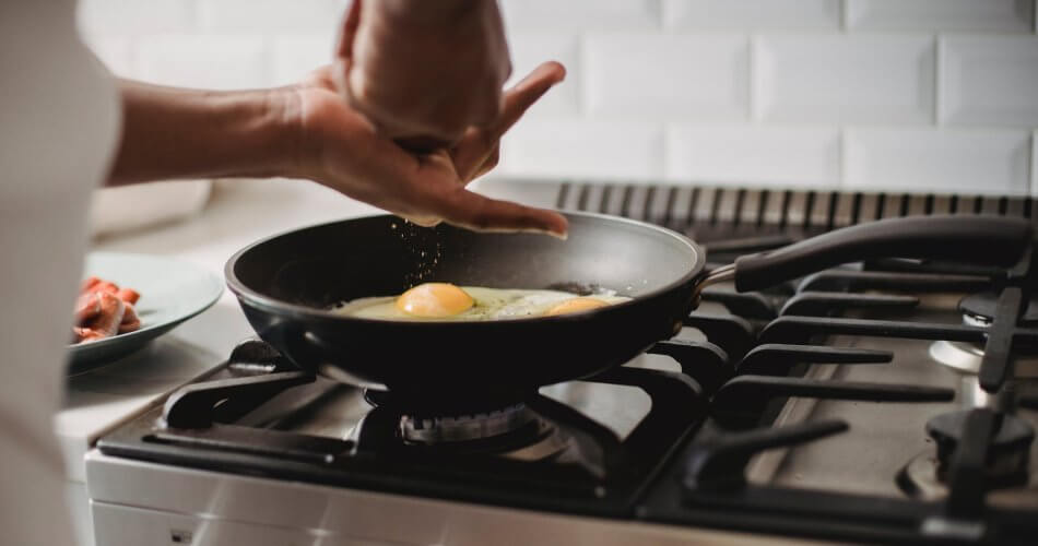 a person cooking eggs
